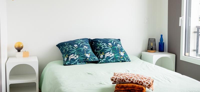 Bedroom 1, double bed with floral cushions